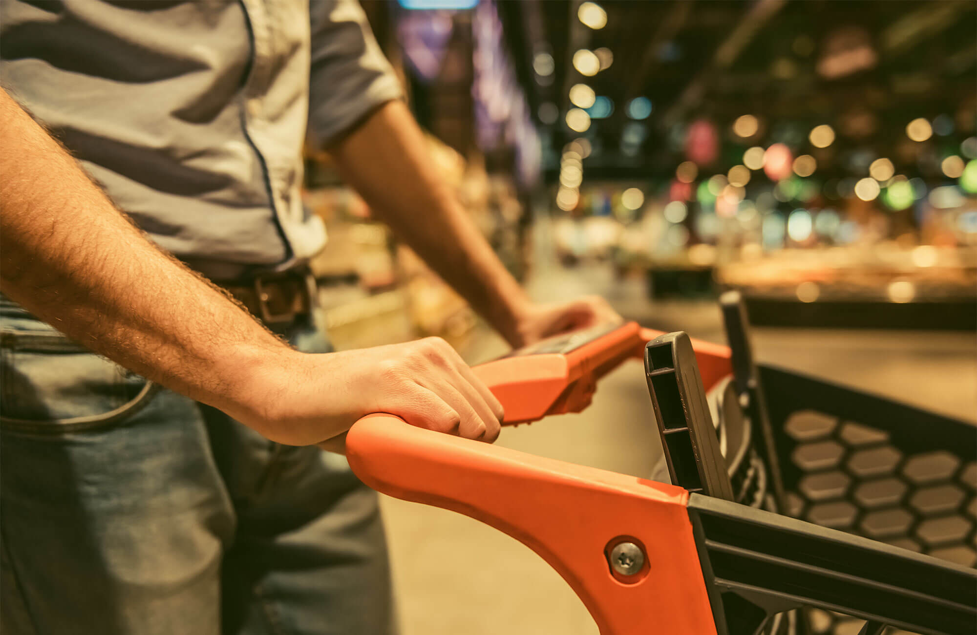 a man pushing a coach through a city